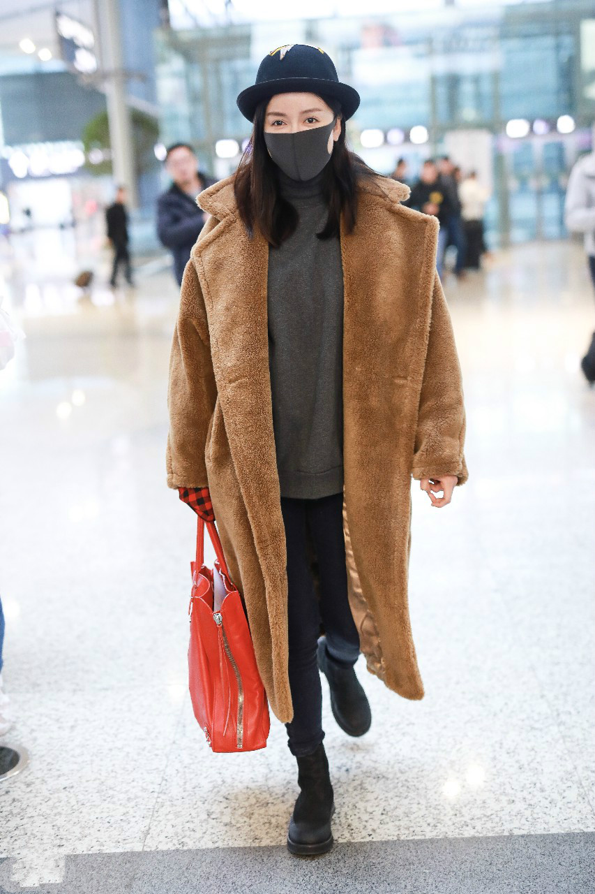 娄艺潇穿棕色长款毛绒大衣现身机场,戴黑色渔夫帽和口罩遮面