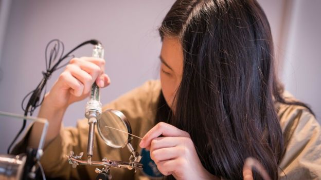 Young maker Tina Jiang soldering.