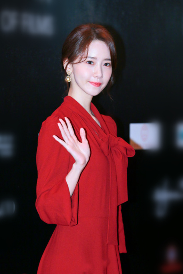 短发的林允儿,身着红衣,配合一脸微笑,令人着迷.