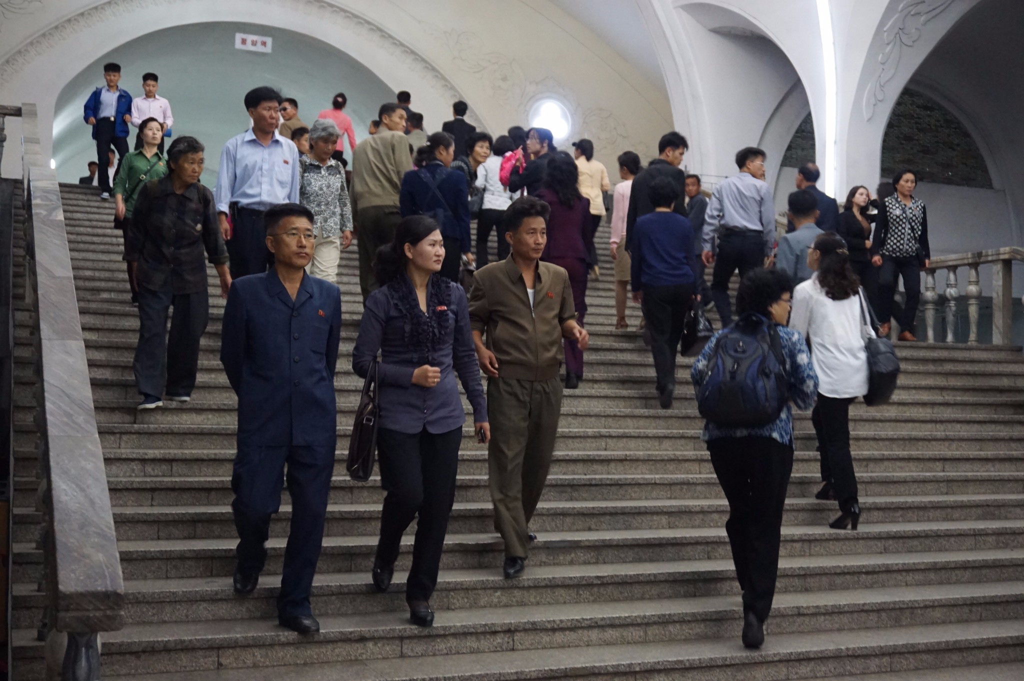 图为朝鲜平壤的地下通道,一名朝鲜女孩抱着文件夹迎面走来.