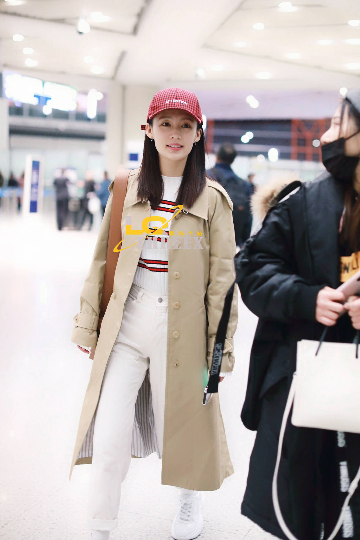 李沁身穿卡其色风衣搭配白色休闲裤,脚踩白色运动鞋.