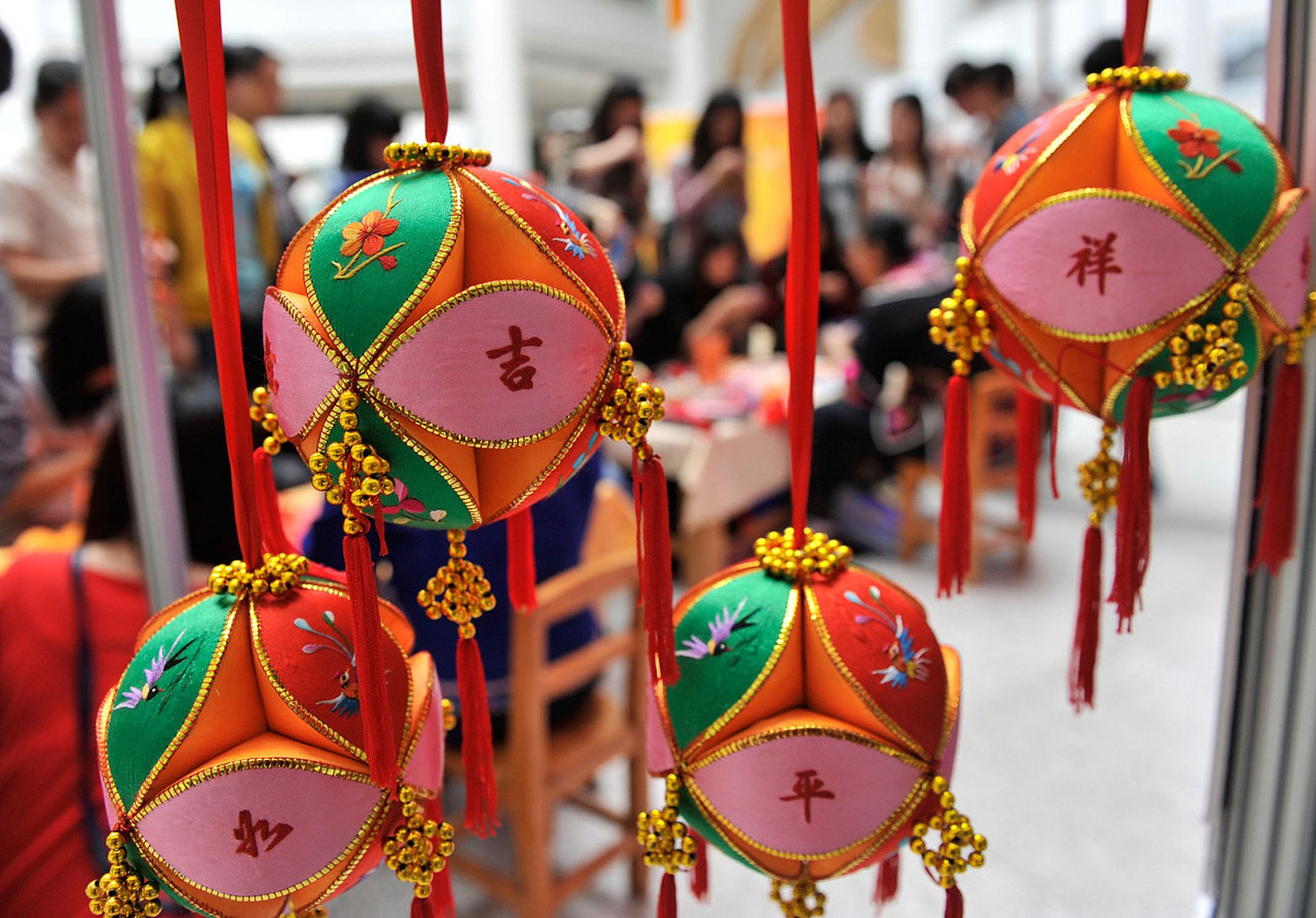 竹等吉祥图案,采用复杂刺绣工艺制成,手工精细,色彩鲜艳,其中堆绣绣球