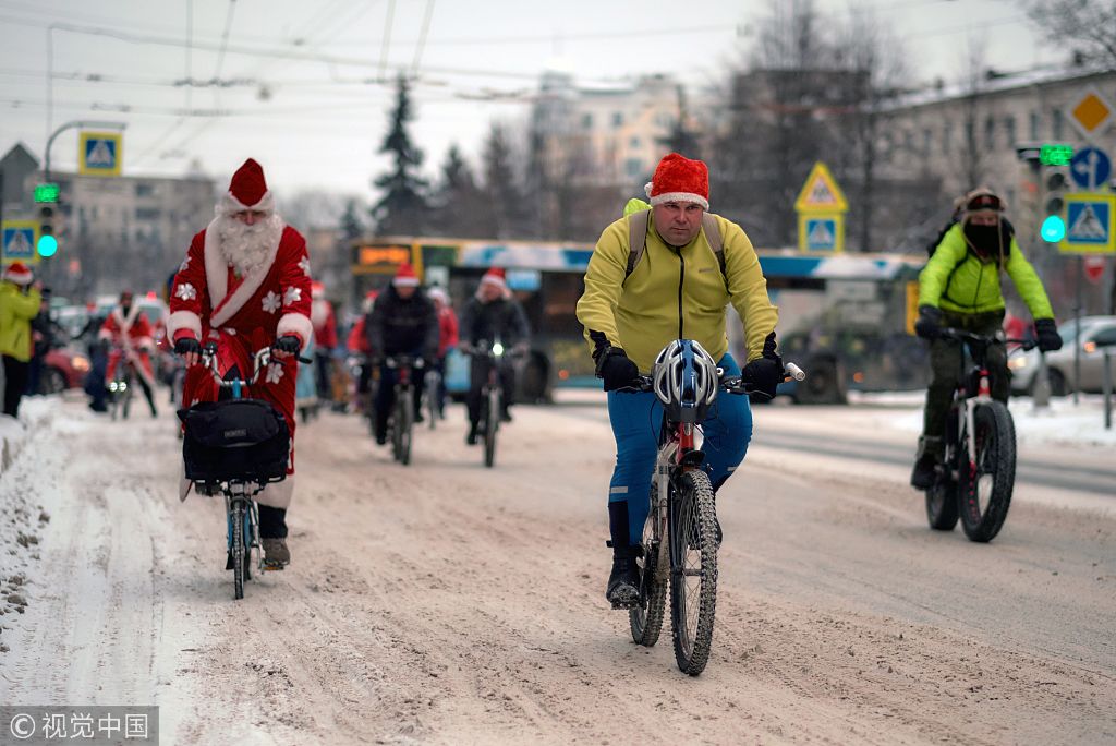 俄罗斯"严寒老人"骑自行车大巡游 后座驮圣诞树画风超萌