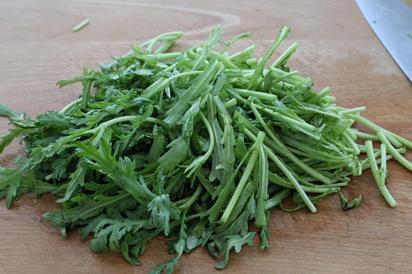 将茼蒿洗净后切成约为7-8厘米的长段,茼蒿杆和茼蒿叶分开放.