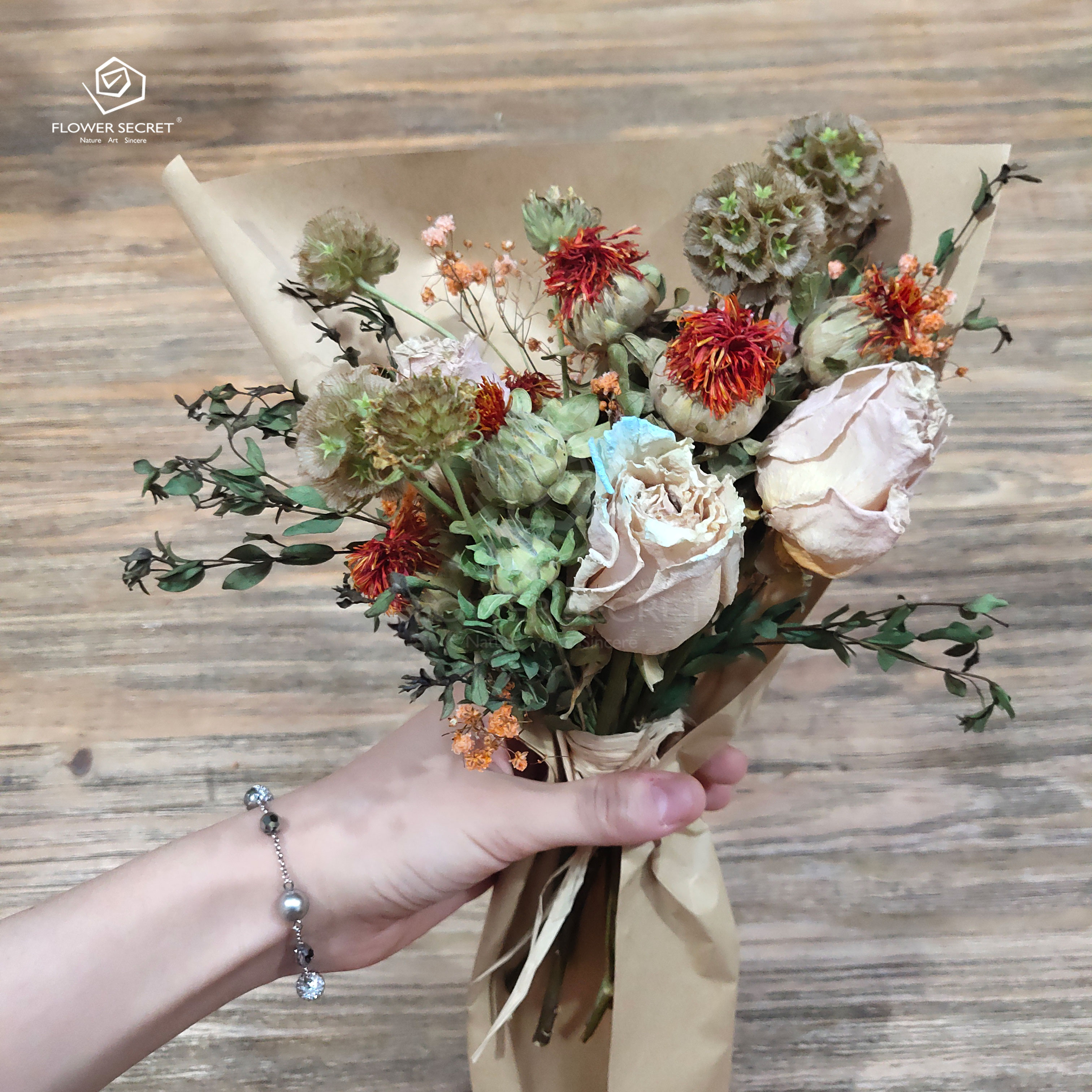 选取一段较长的拉菲草用来捆绑花束,捆绑干花的时候力度松紧适中,以