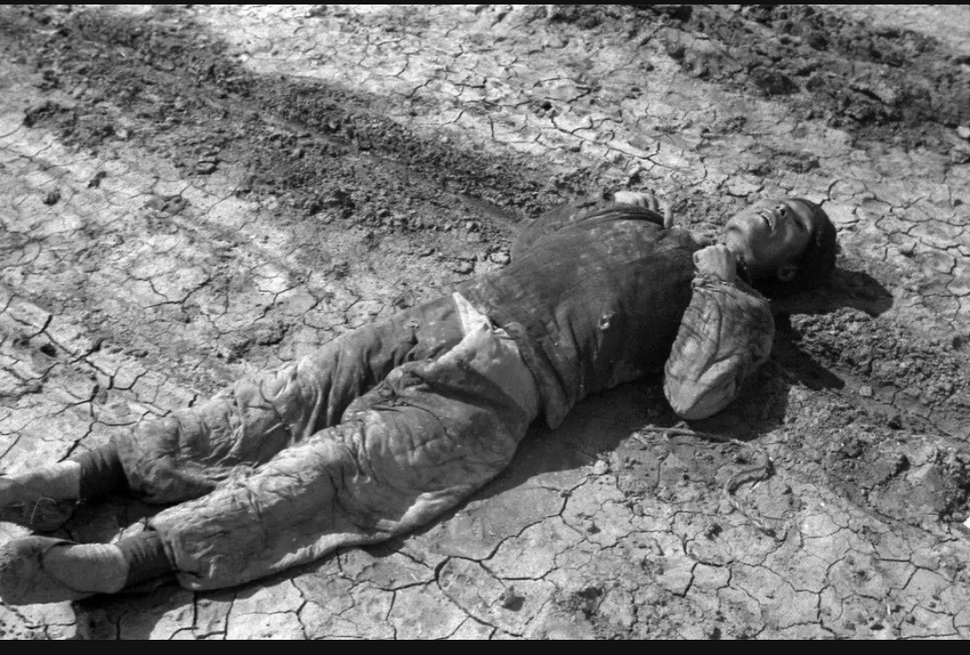 这是民国时期,一名被饿死在路边的饥民,照片中的他躺在干裂的土地上