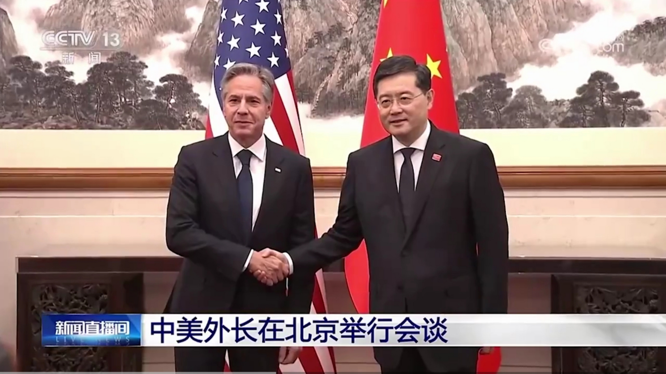 中美外长会见现场画面曝光.两位外长握手,身后是两国国旗.