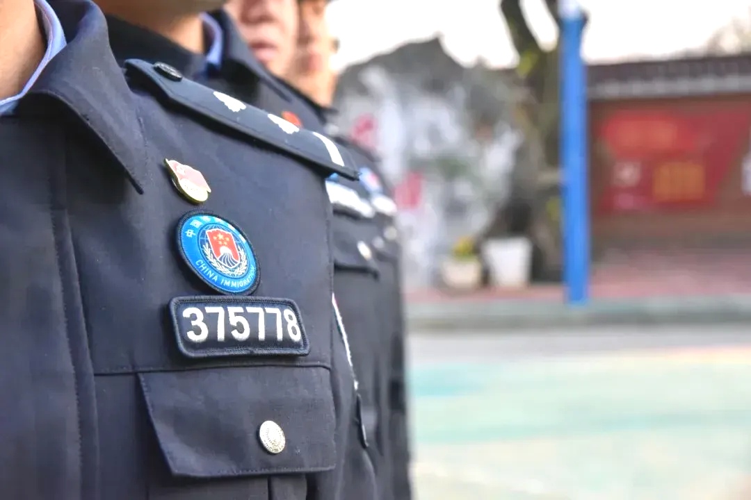 下面有"中国移民"的英文辅章,原来左臂的"警察"臂章被移置到了右臂