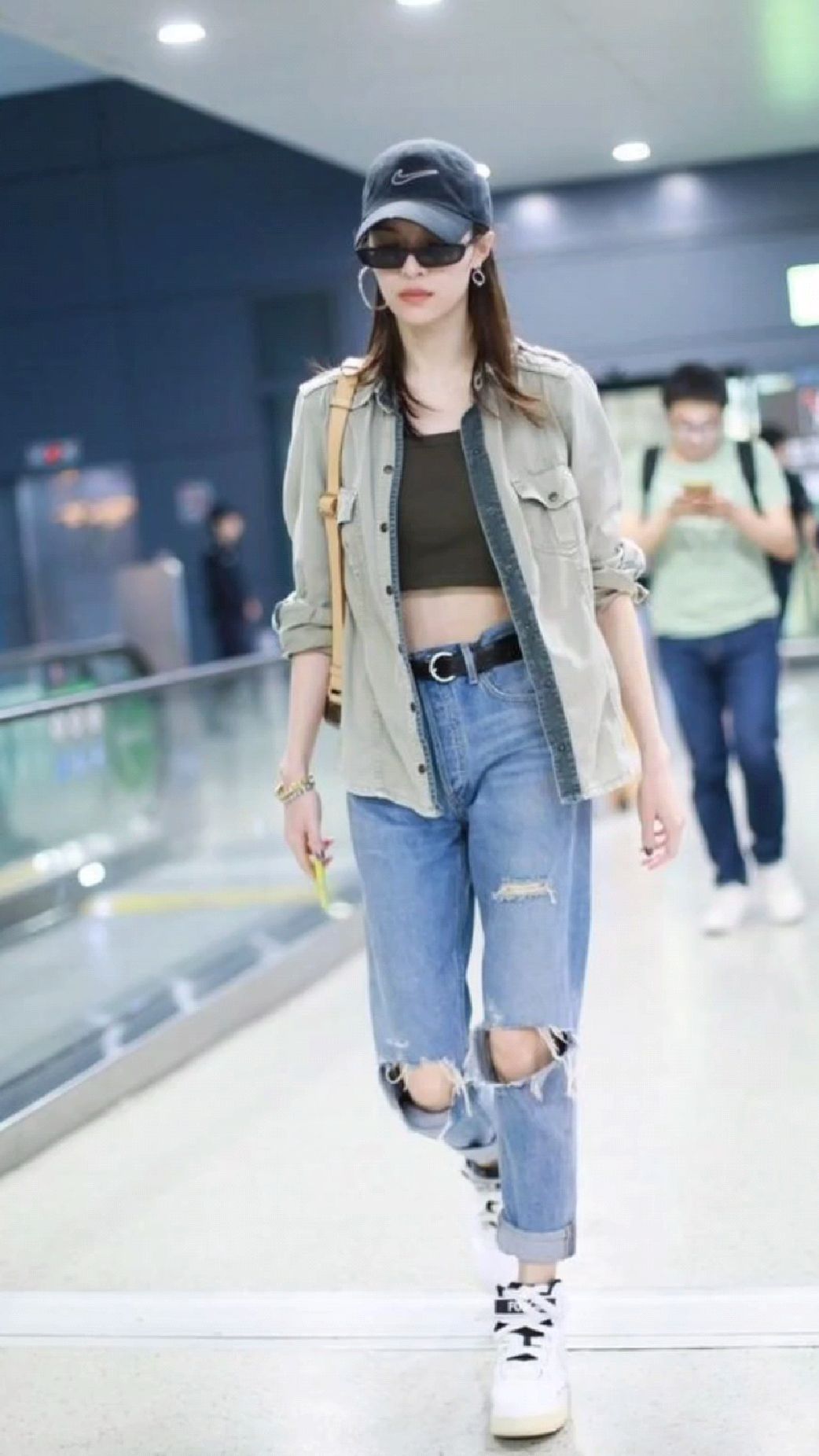 钟楚曦穿衣个性时髦,工装风衬衫叠穿黑色露腹装,搭配破洞牛仔裤