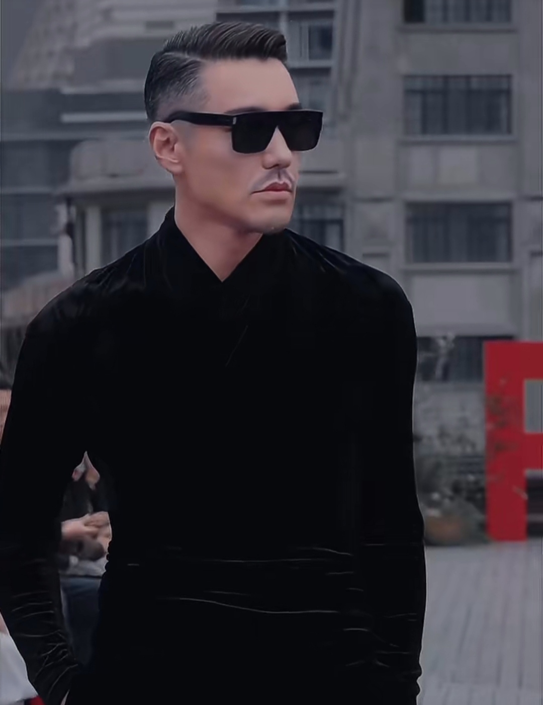 胡兵身穿黑色西装外套内搭整洁的白色衬衫显得既庄重又不失洒脱