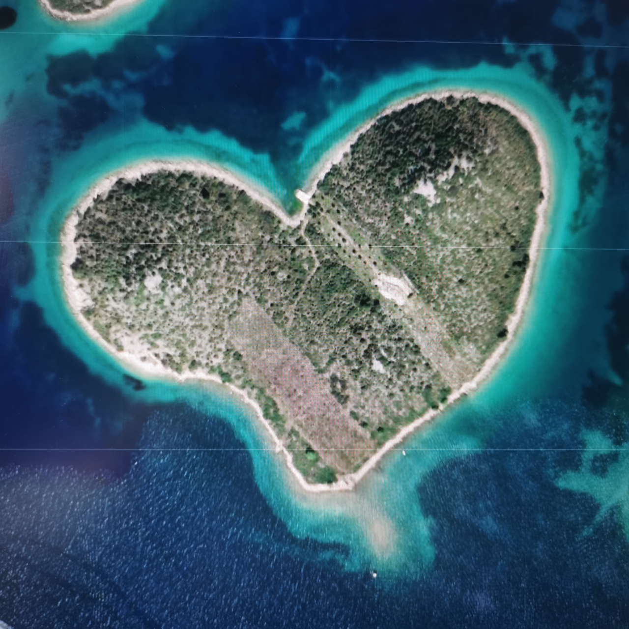 卫星图下的心形岛 位于东经15度23分,北纬43度58分 属于克罗地亚,是