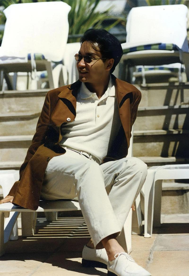 张国荣一组生图,身穿白色服装,外搭黄色上衣,配戴精致墨镜,真的好帅