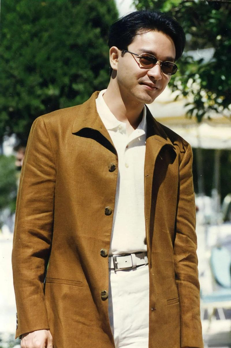 张国荣一组生图,身穿白色服装,外搭黄色上衣,配戴精致墨镜,真的好帅