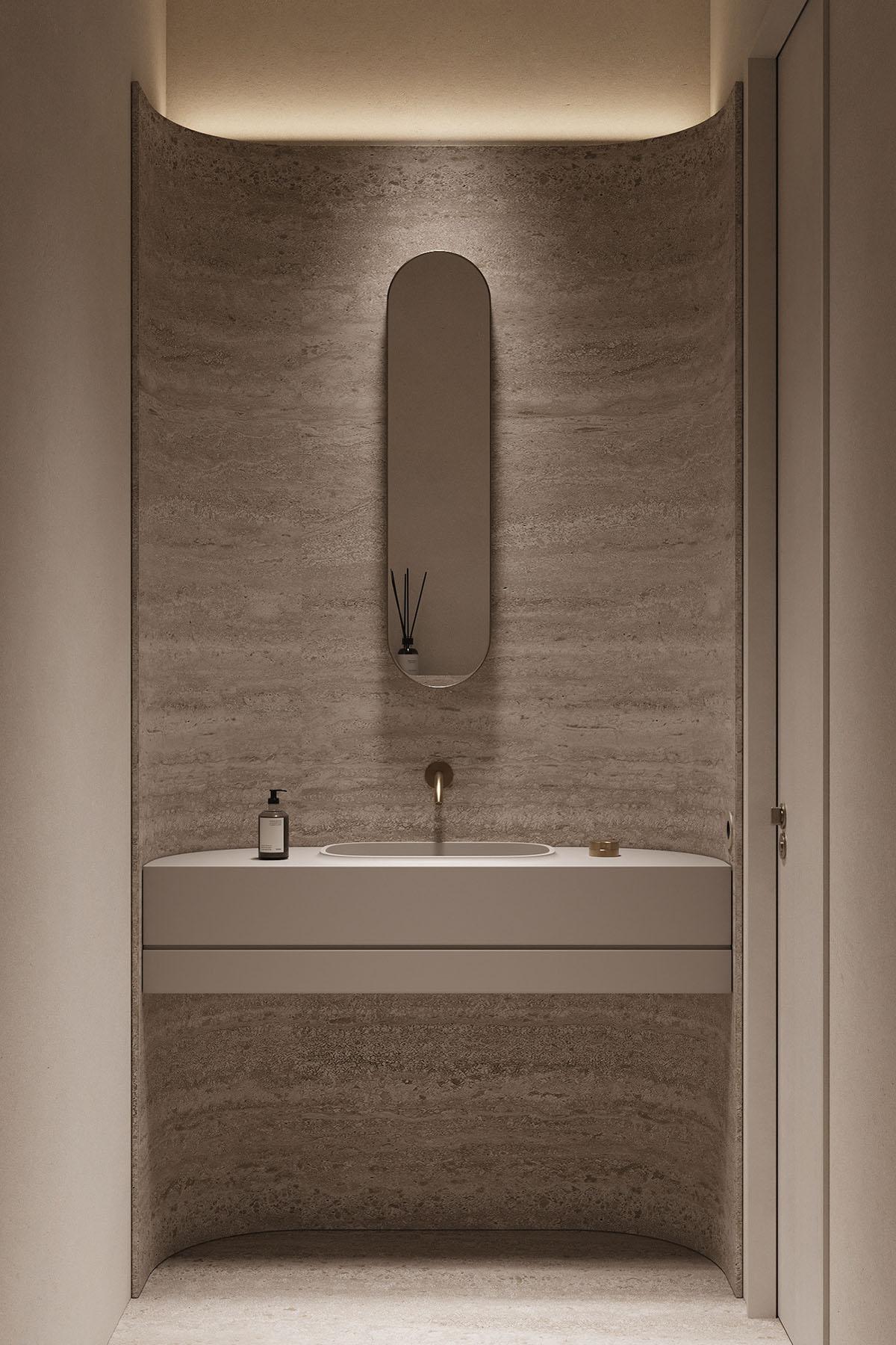 浴缸是一种舒缓的灰色设计,内有安装在墙上的水龙头.