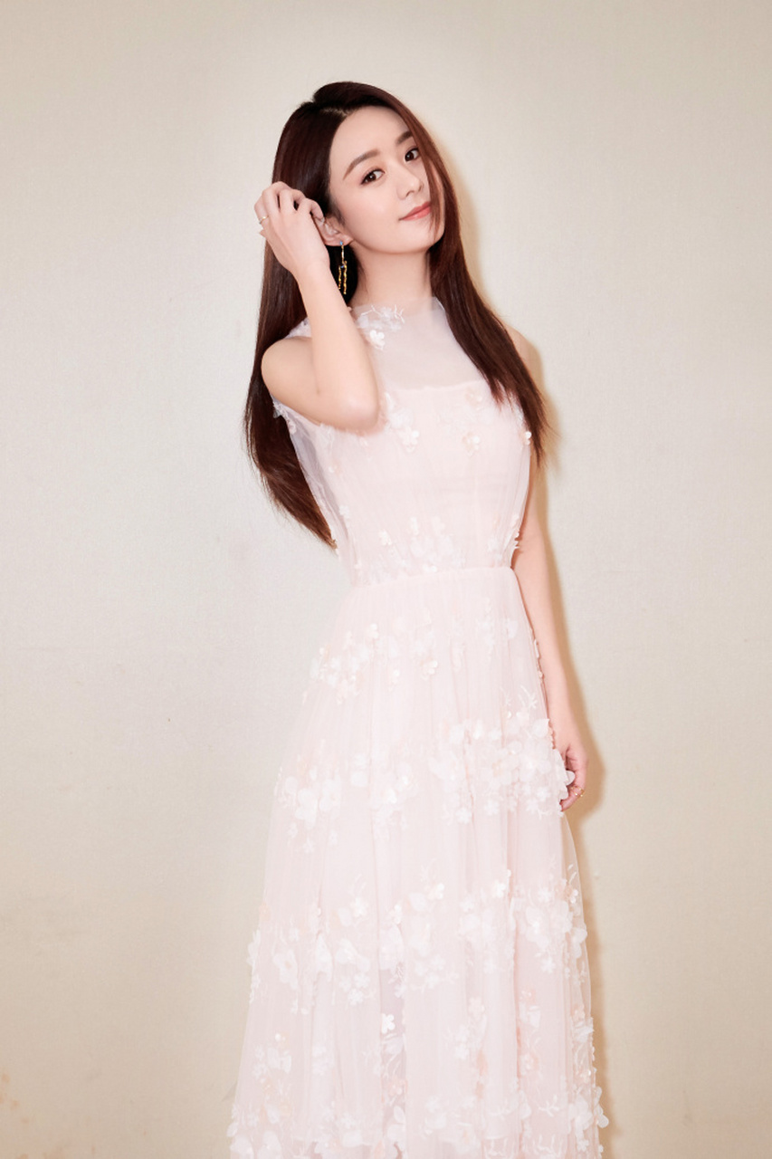 赵丽颖身穿白色长裙,对镜头浅浅微笑,气质动人.