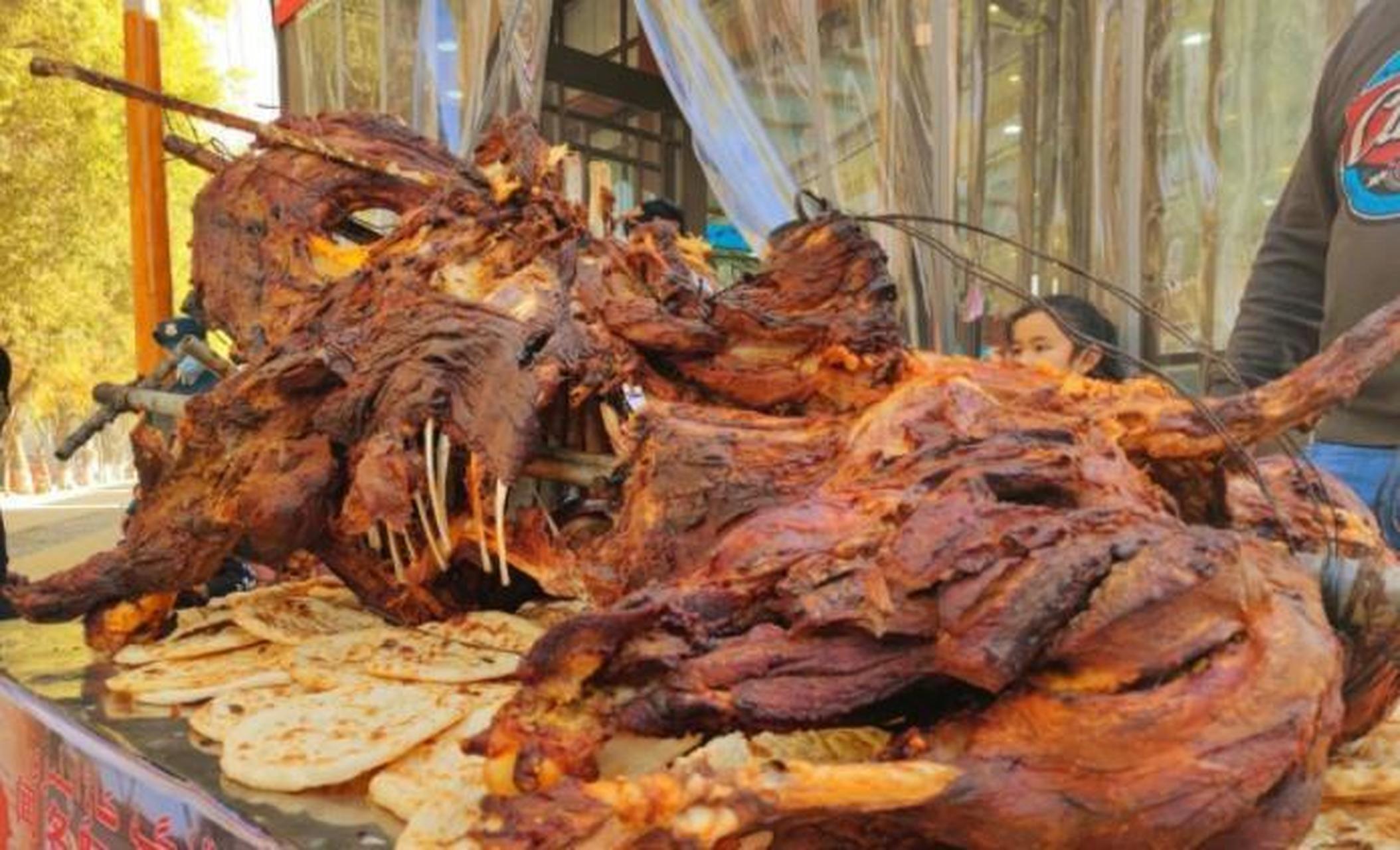 烤骆驼是阿拉伯国家一道国菜,骆驼被掏空内脏,一只烤全羊会被置于骆驼