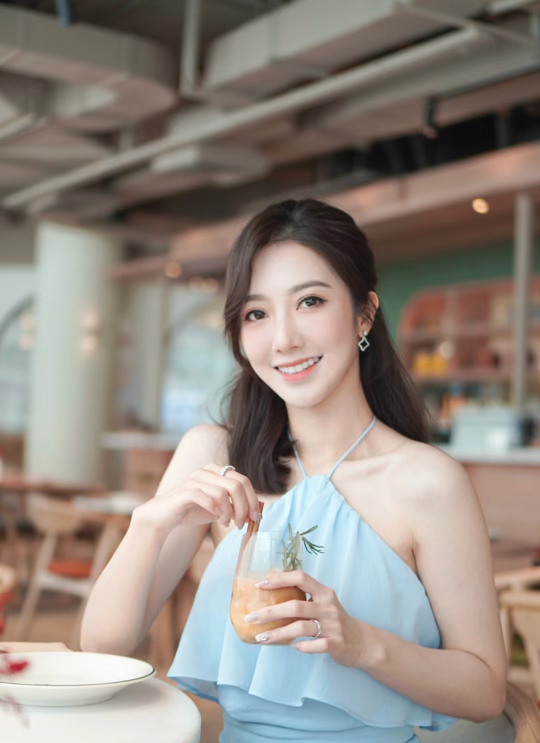 何依婷今日晒出自己在泰国的旅游照片她身穿一袭挂脖式的青色上衣手