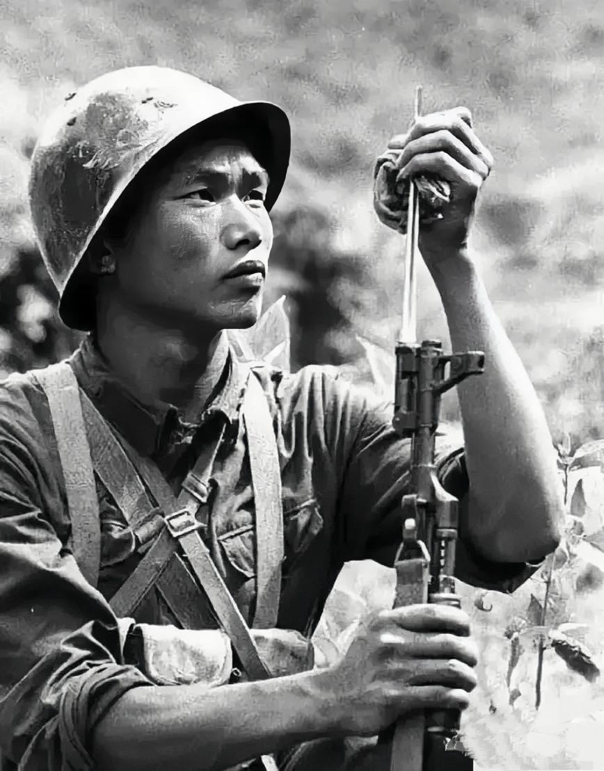 1984年老山轮战期间,一名战士在战斗间隙精心擦拭着枪上的"三棱刺刀"