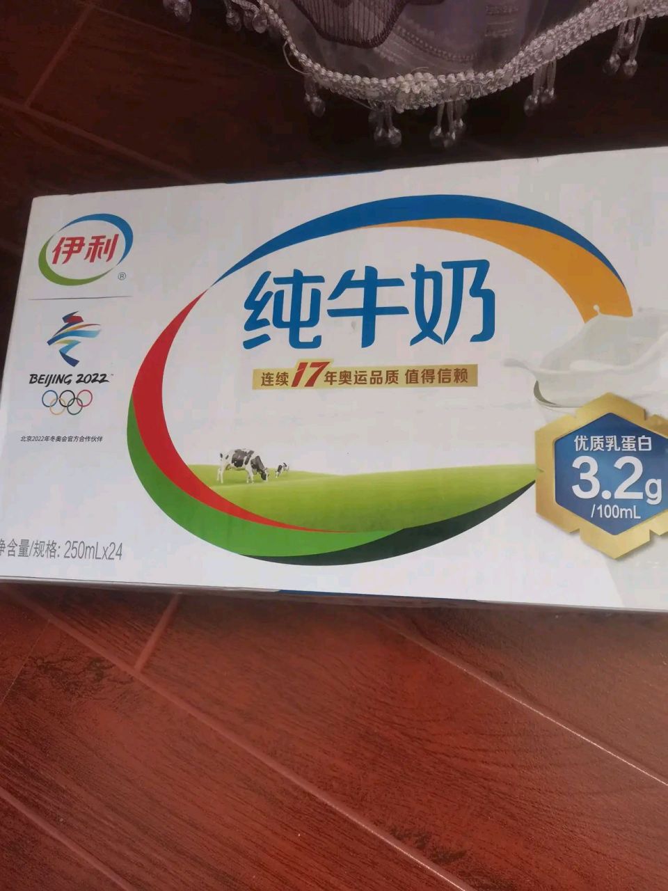 图一伊利纯牛奶是超市买的63一箱,包装图片上是头黑牛,图二是下面是