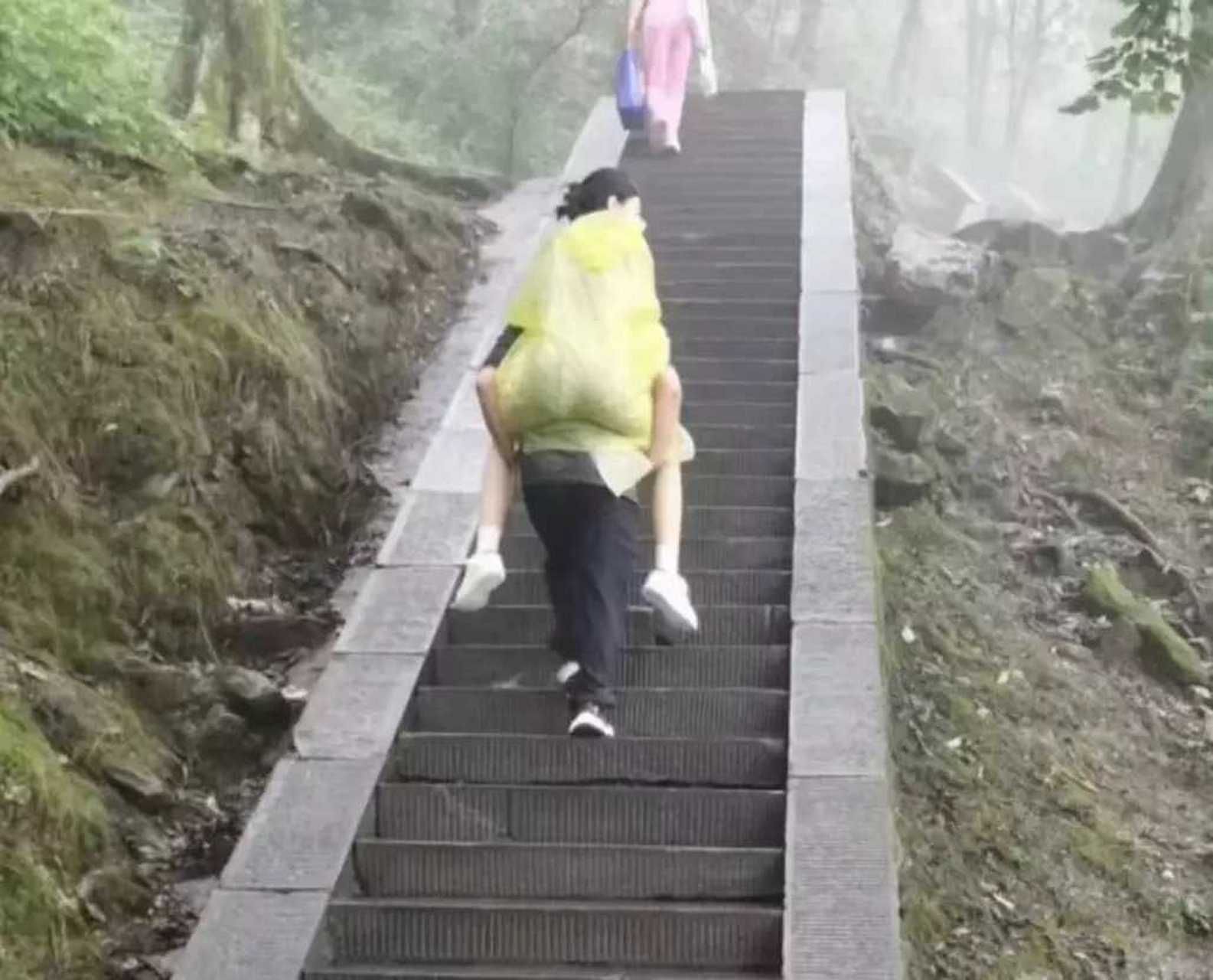 一对儿年轻的小情侣,男孩背着女孩再爬山,男孩即使很累,这一刻他觉得