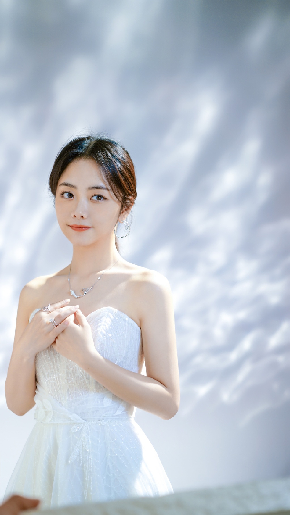 谭松韵穿着白色抹胸公主裙乖巧捧脸可爱十足,旗袍造型则温婉可人