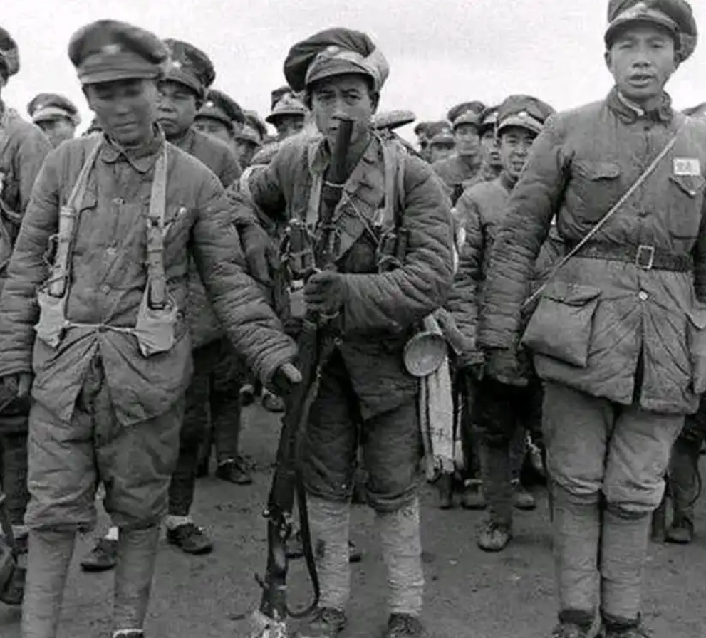 1946年,解放战争初期的国军士兵,身着黄绿色军装,肩扛步枪,眼神中透露