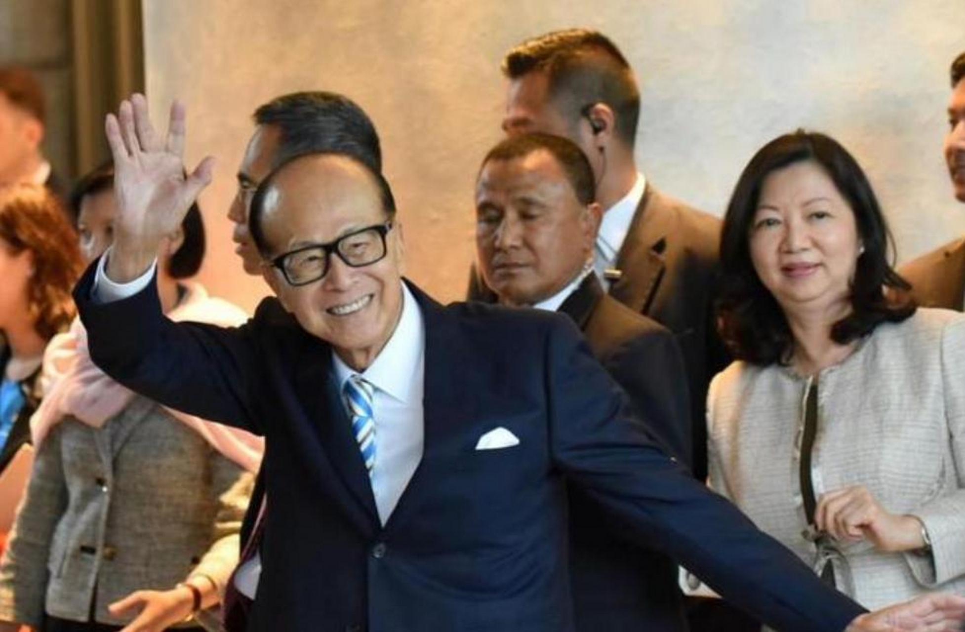 照片中,李嘉诚的庄月明戴着一副时尚的墨镜,优雅地站在丈夫和两个儿子