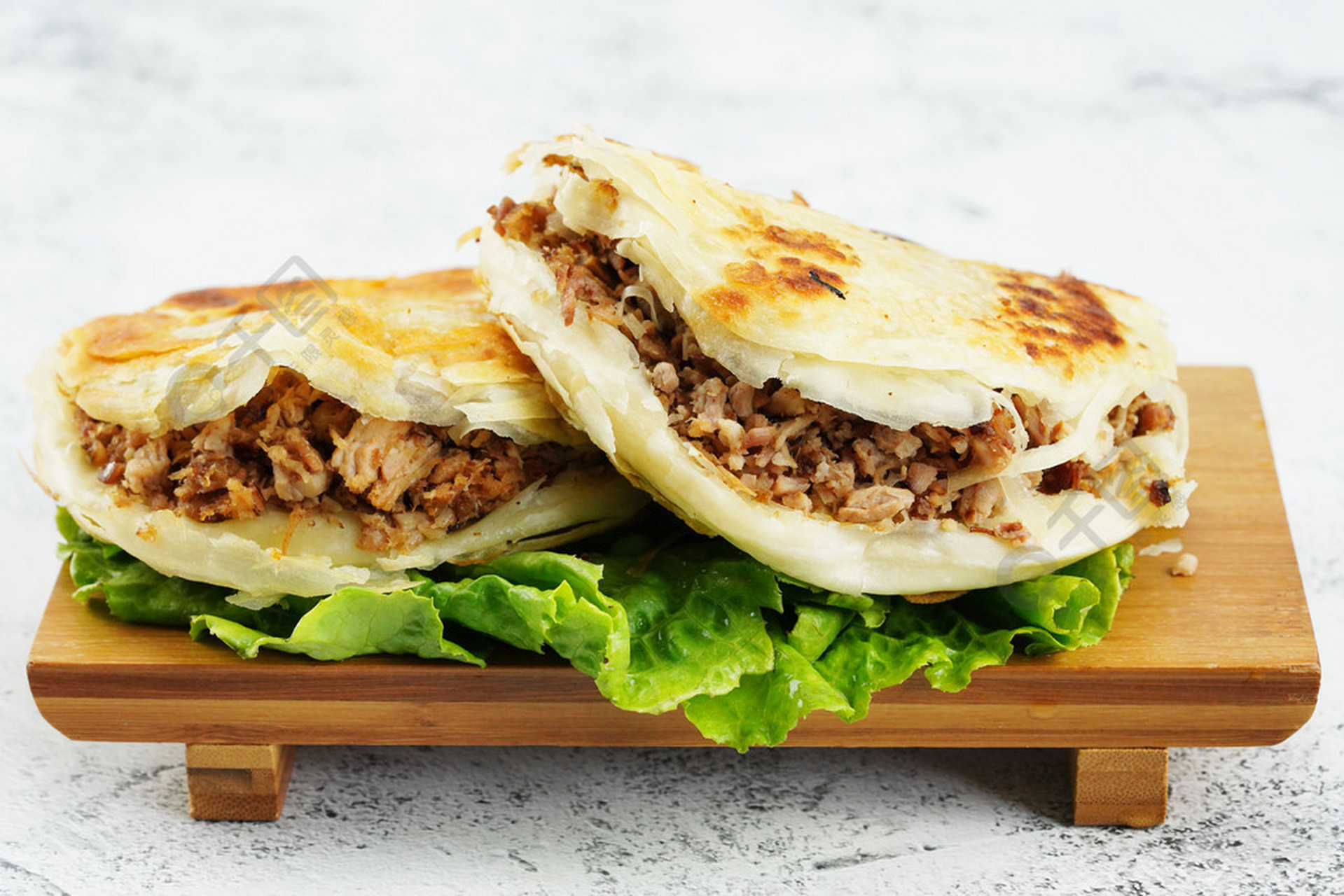 陕西地区有使用白吉馍的「腊汁肉夹馍」,宝鸡西府的是肉臊子夹馍,潼关