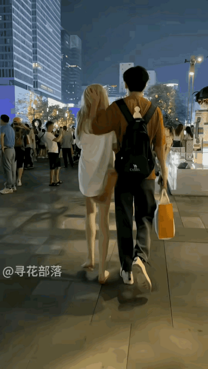 炎炎夏日的夜晚,路人拍下街上一对情侣逛街,图片中的女生穿着引发了