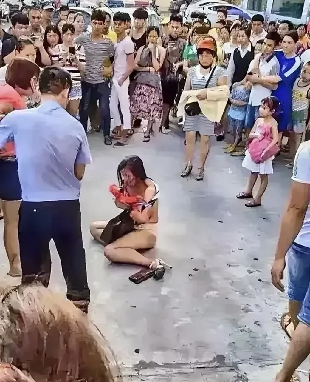 小三被原配脱光衣服,打倒在地,原配被警察拉住,仍然忿忿不平.