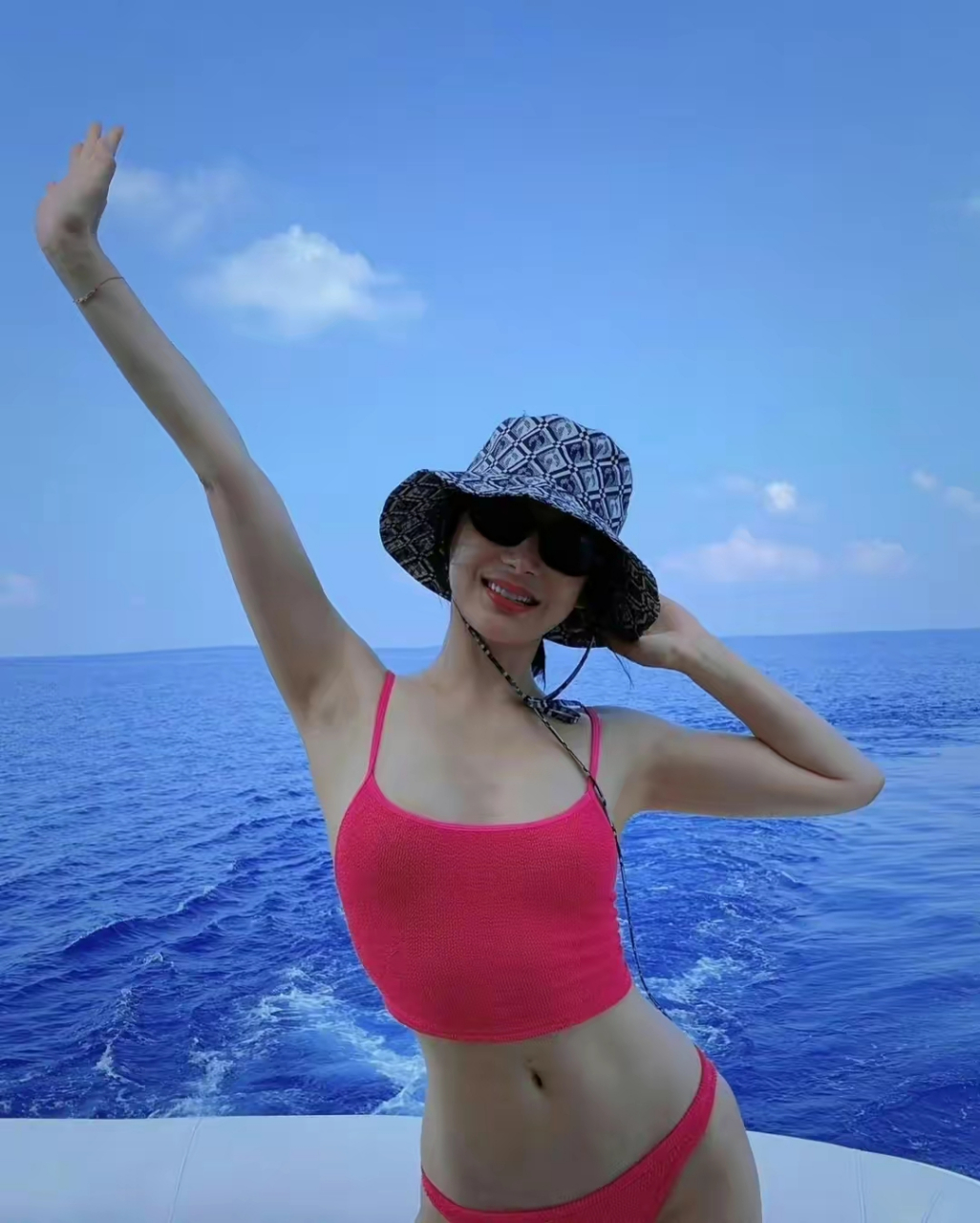 袁姗姗穿着粉红色比基尼泳衣出海以及在海边游玩的照片.