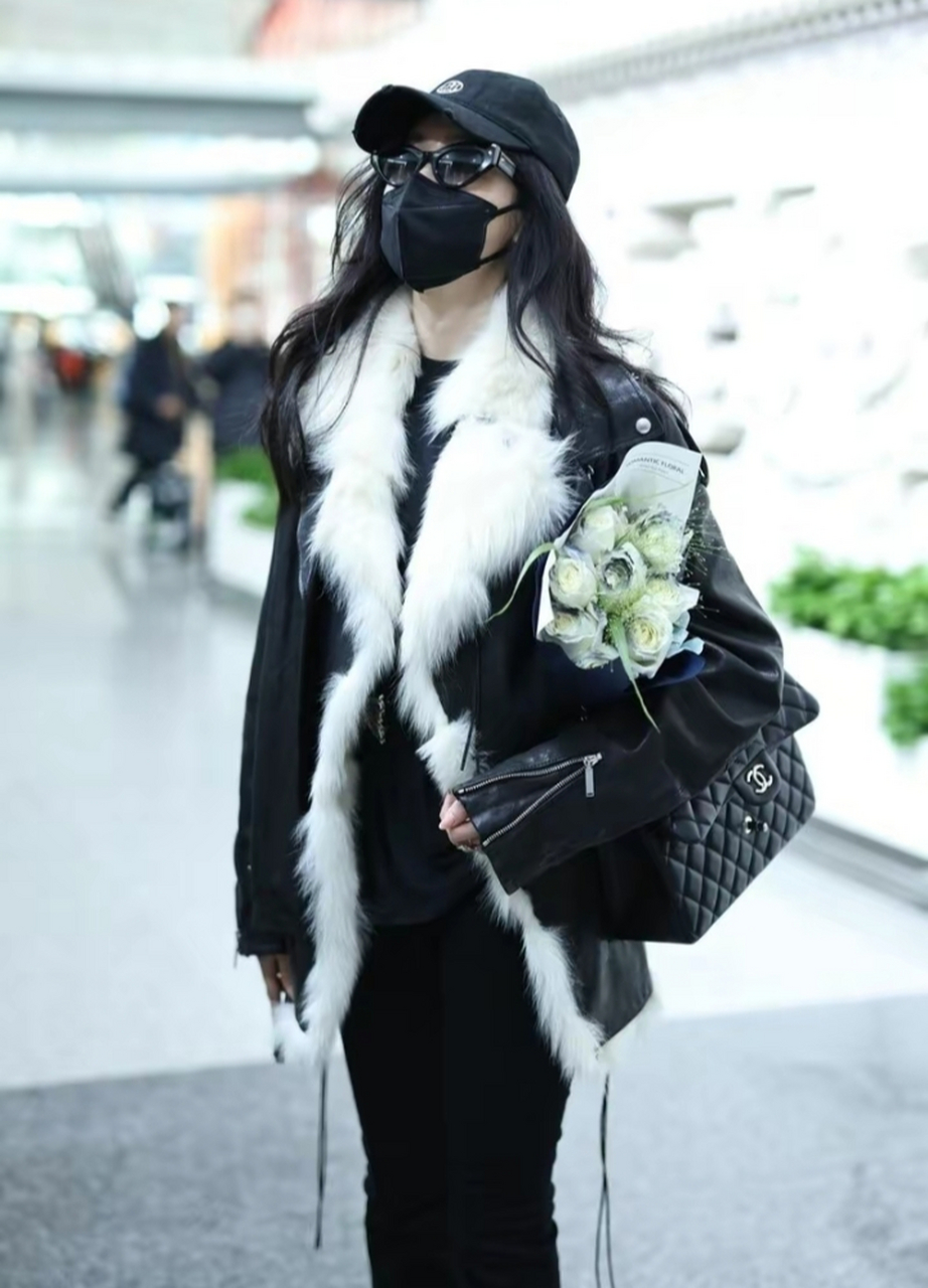 张天爱最新机场街拍穿搭 翻毛黑色皮衣搭配黑色紧身裤 头上戴了一顶