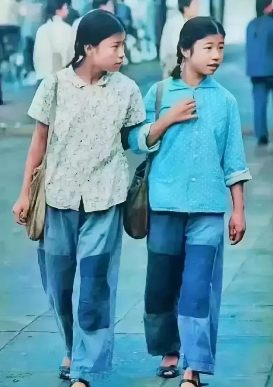 这是70年代初,穿着 补丁"衣服的两个女孩,昂首阔步的走在大街上,照片