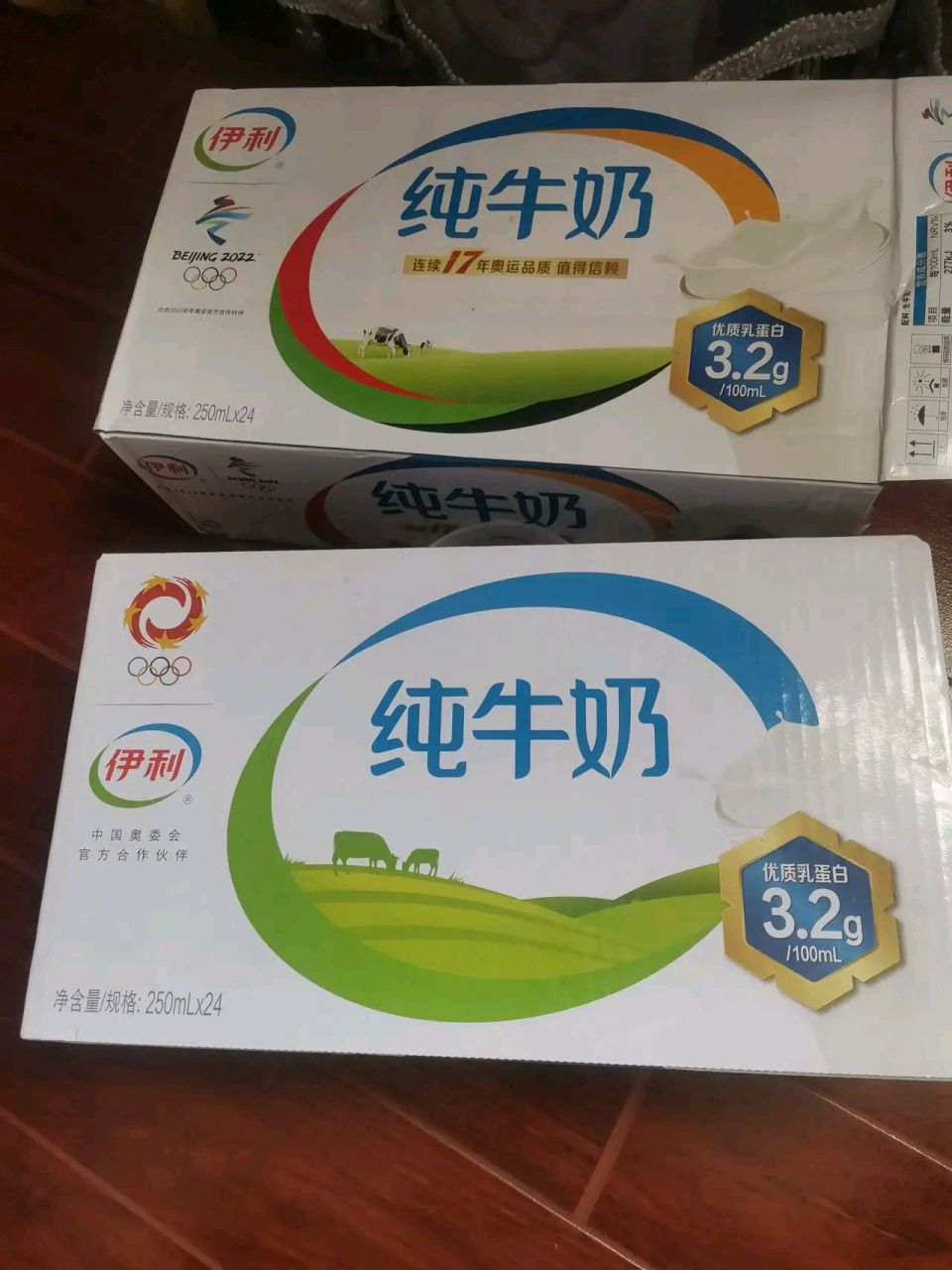 圖一伊利純牛奶是超市買的63一箱,包裝圖片上是頭黑牛,圖二是下面是