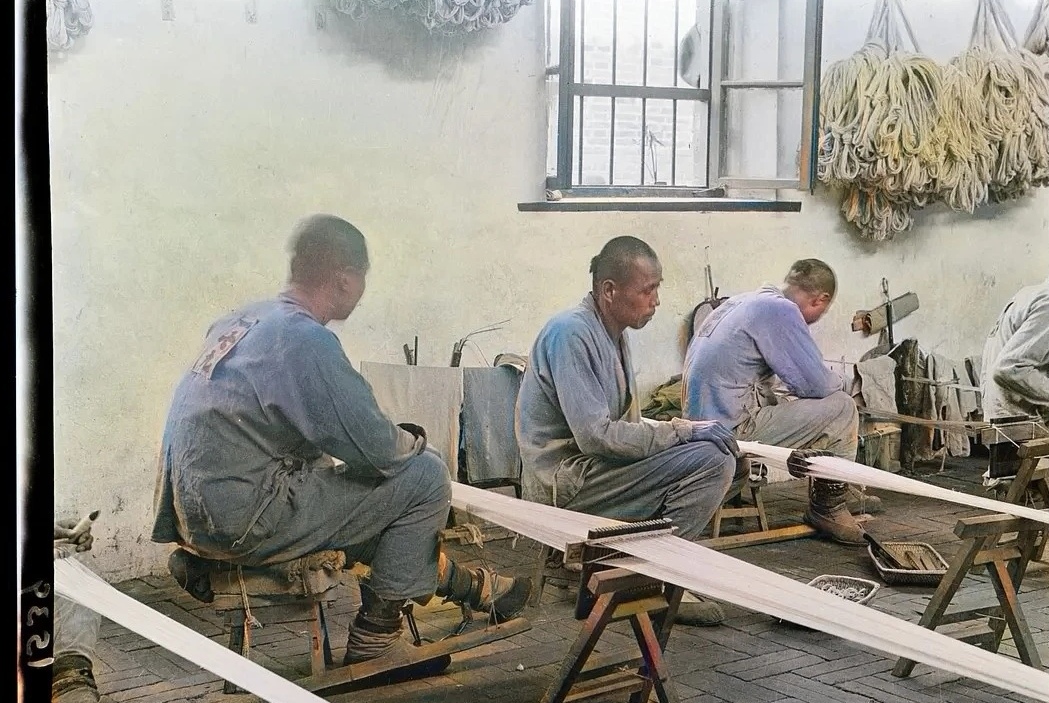 民国时期的北平城中一座监狱中,几名正在劳动改造的犯人正在织布机前