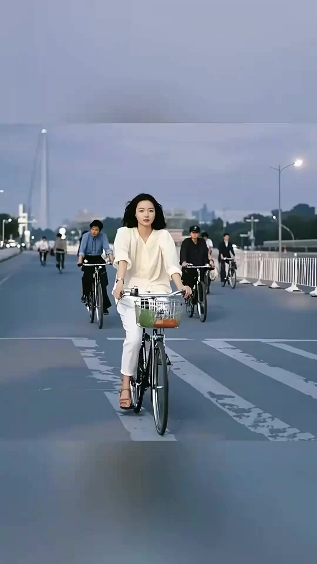 1983年一个女孩穿着的确良衬衫,骑着26型凤凰牌自行车往家赶