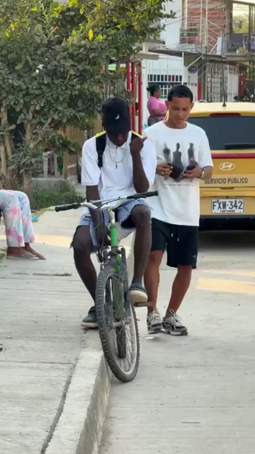 海外:非洲黑人小伙坐在单车上时,被路人故意丢钱包演技恶搞真会玩