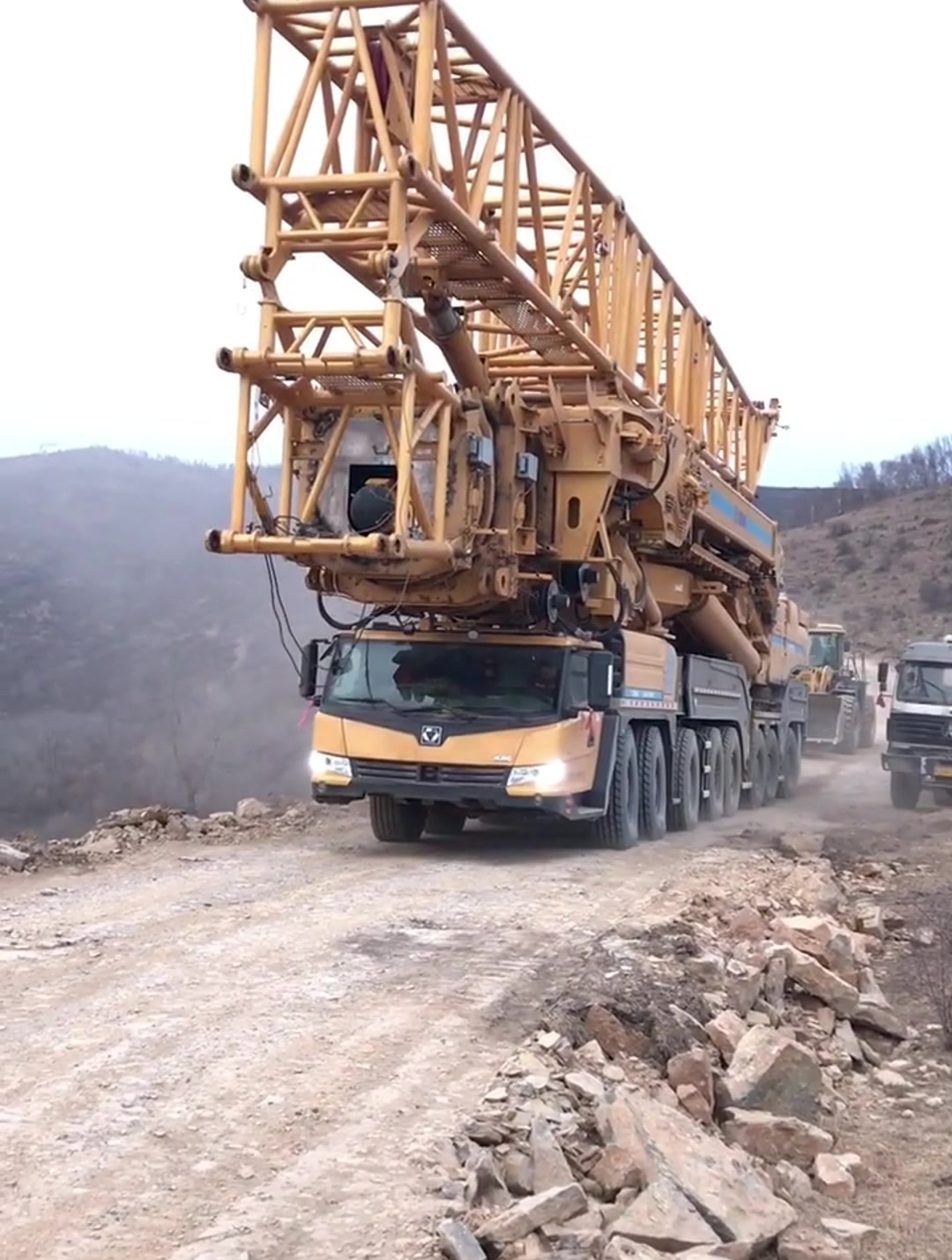 这是我见过最牛的1200吨吊车,自己爬坡,后面还能拽个装载机