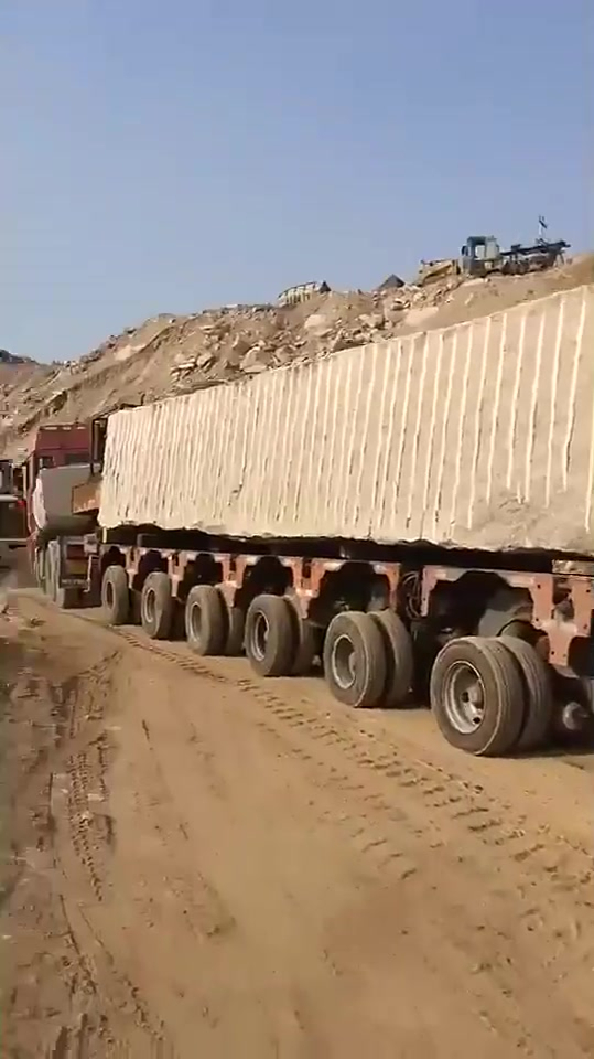 车上的这块石头真长,真大,我目测得二三百吨!