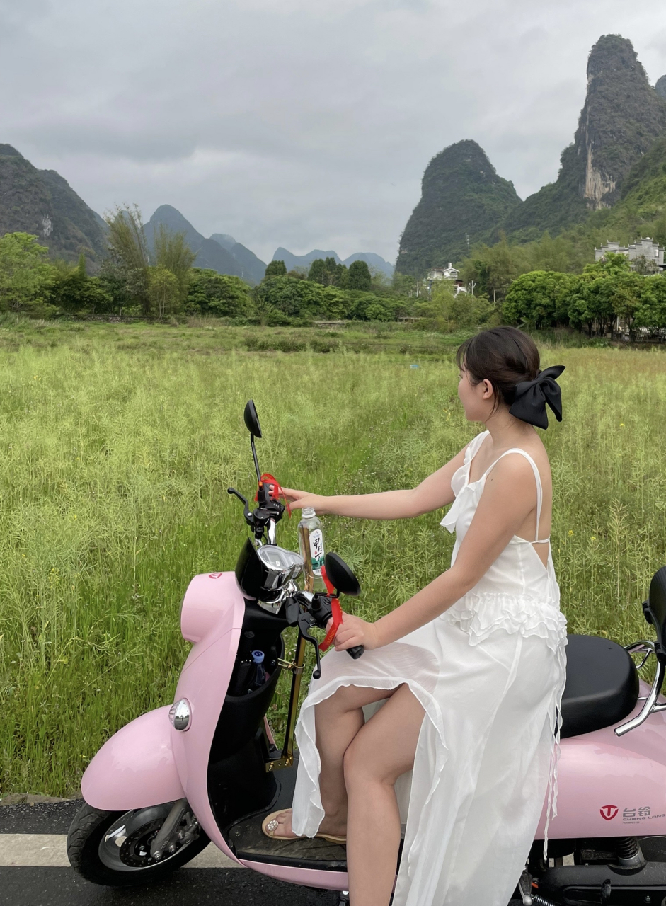 桂林旅游时路边遇到的骑着小电驴的白裙美女