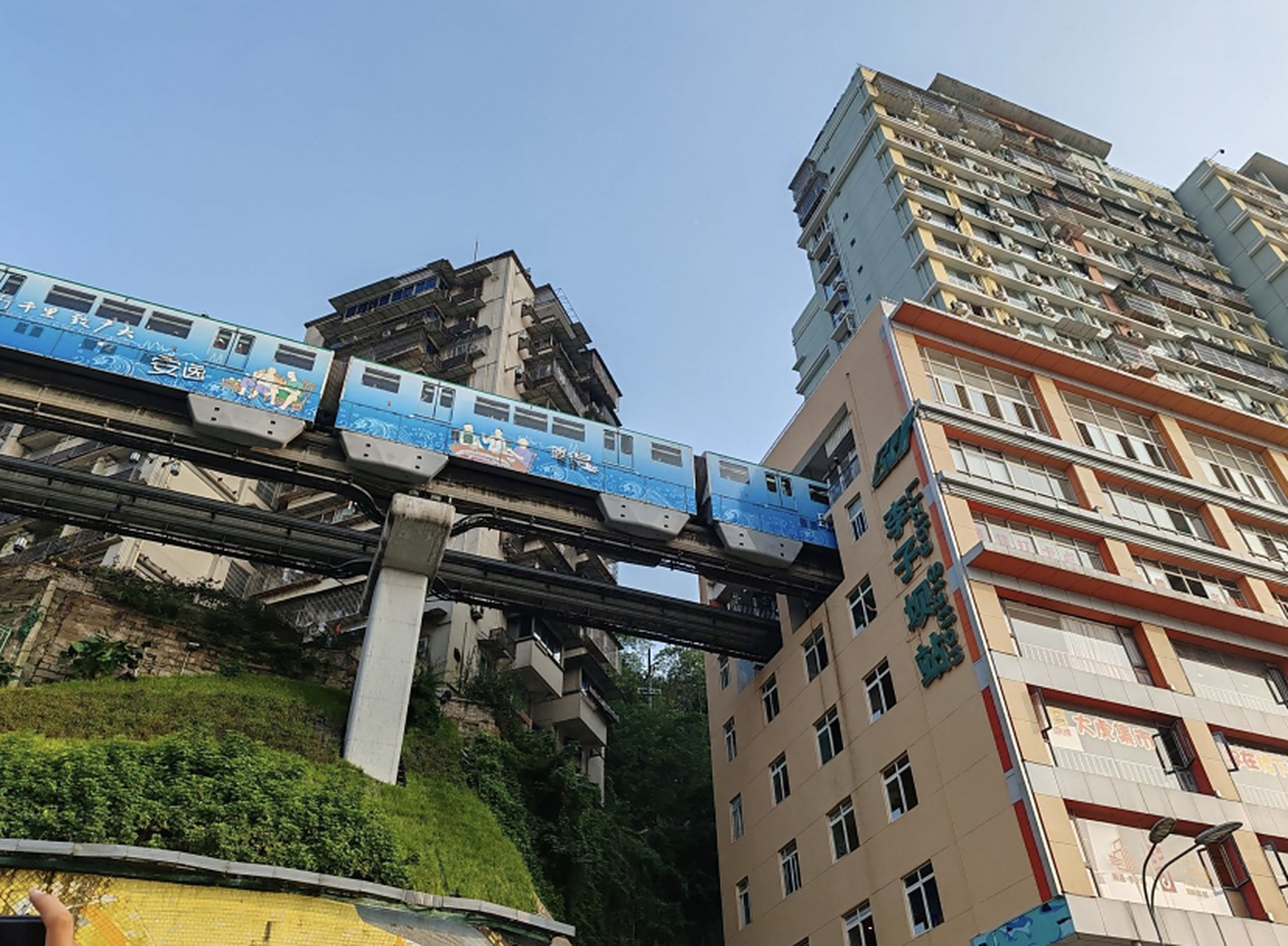 李子坝单轨穿楼,是一座楼宇与轻轨列车穿堂而过的奇观,是重庆独特的