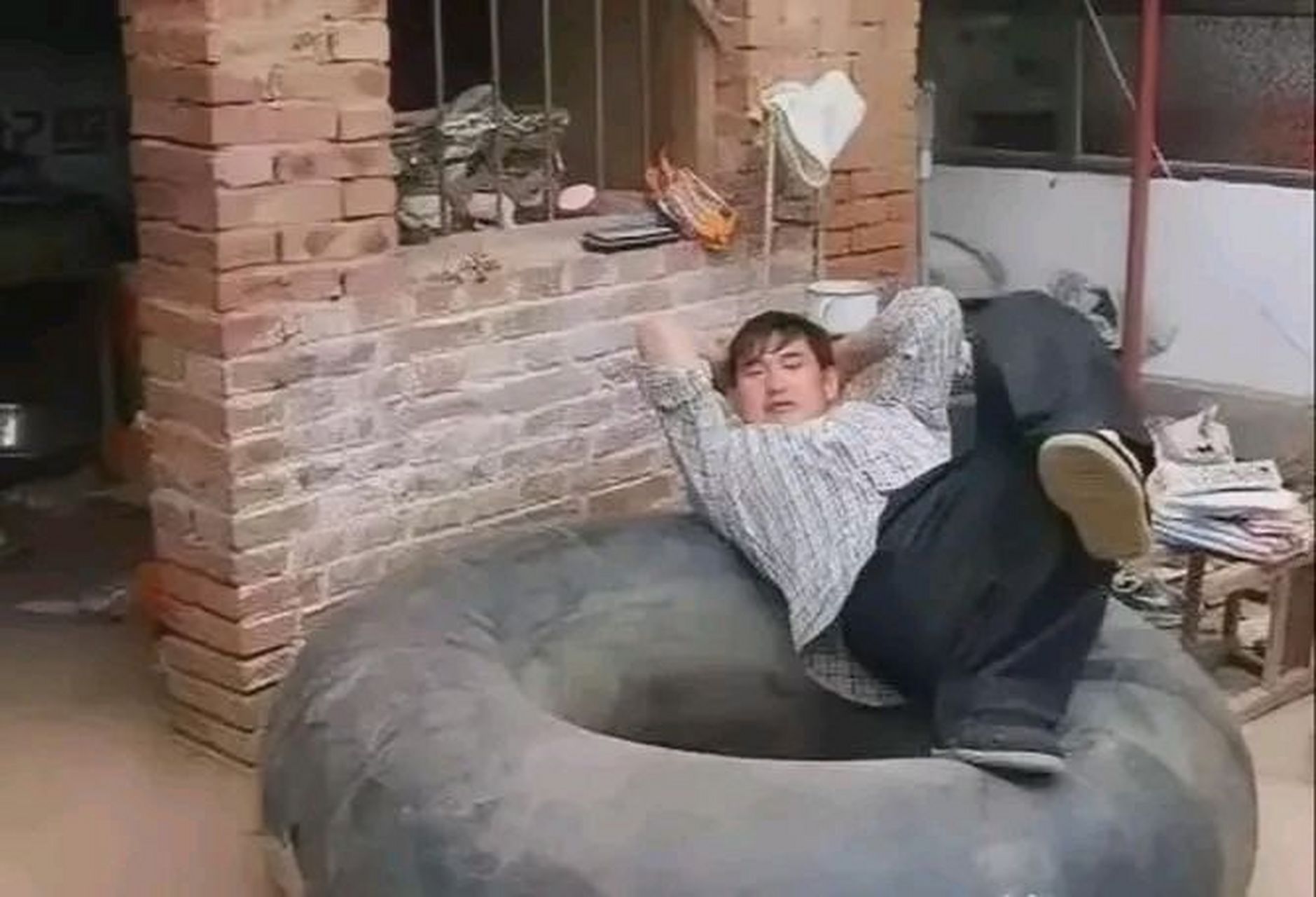 第一张,是成名前的大衣哥,落魄地躺在一个大轮胎