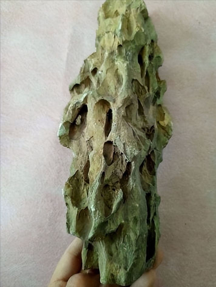 这种黑石头叫梭罗树化石,是上万年的古木,切开一看里面全是眼睛