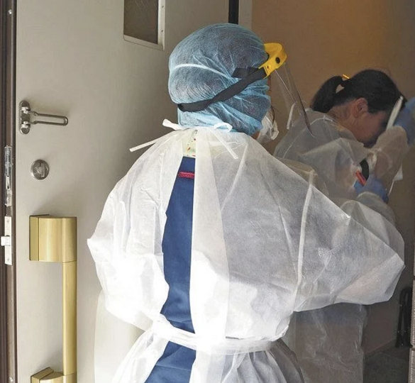 东京都护士在新冠患者家门前穿戴防护服(图片来源:日媒)