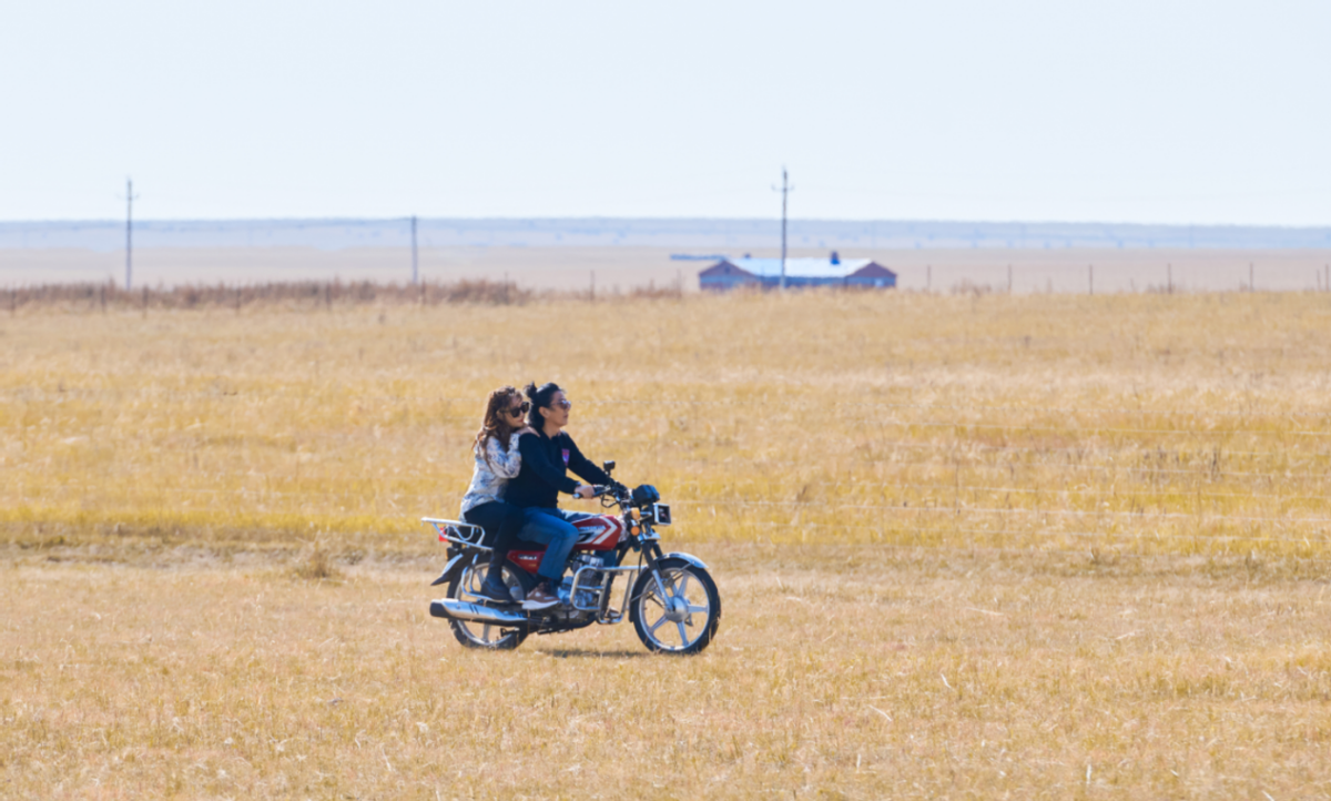 55岁郑钧骑摩托载妻子赶羊,扎小辫打扮帅气,夫妻俩搂抱秀恩爱