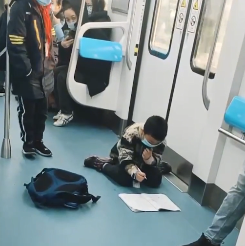 重庆小学生开学的第一天,趴地铁车厢内写作业,看完后网友都笑了
