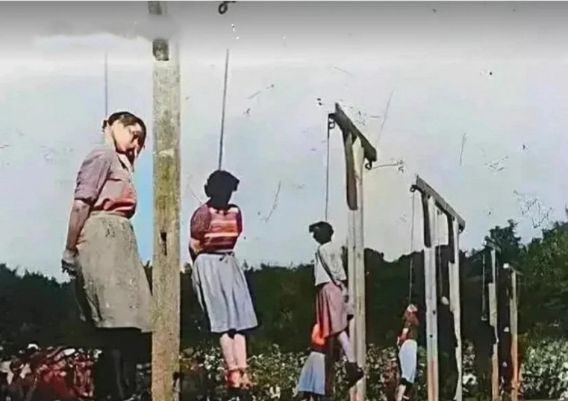 1946年,纳粹集中营"达豪集中营",几名德国女看守被吊死在柱子上,她们