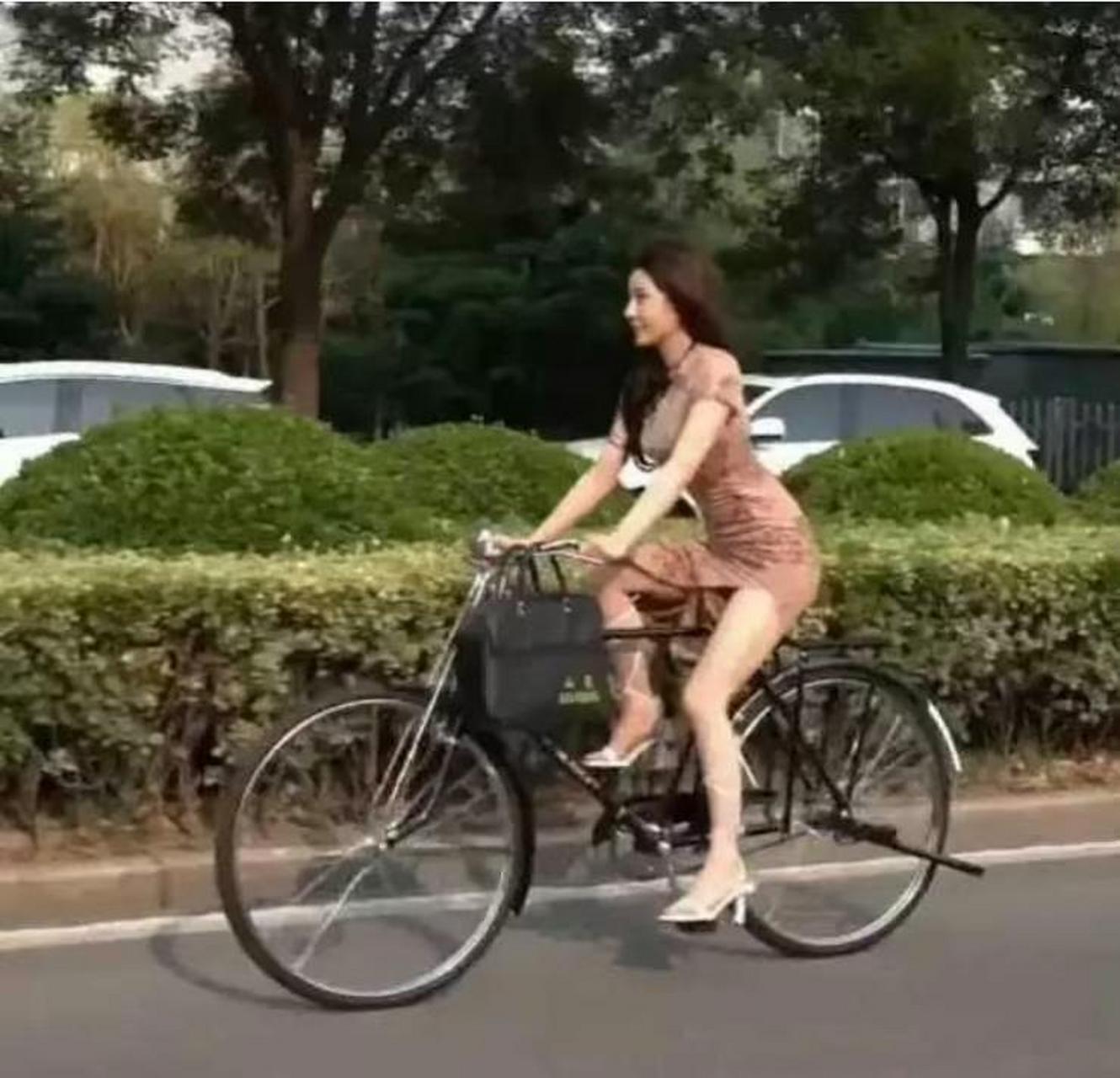 骑自行车的时候穿裙子和高跟鞋有点不合适.