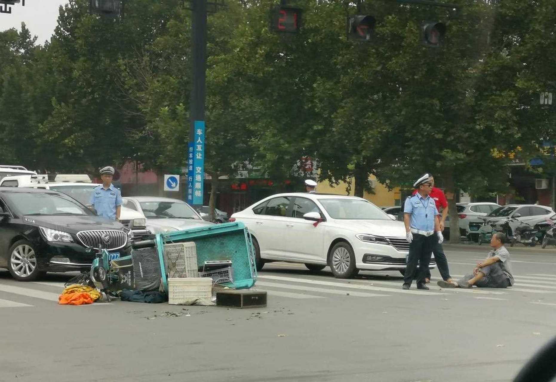 青州瓜市街路口出车祸了,买桃得大爷被撞在路上,幸好看着伤势不厉害.