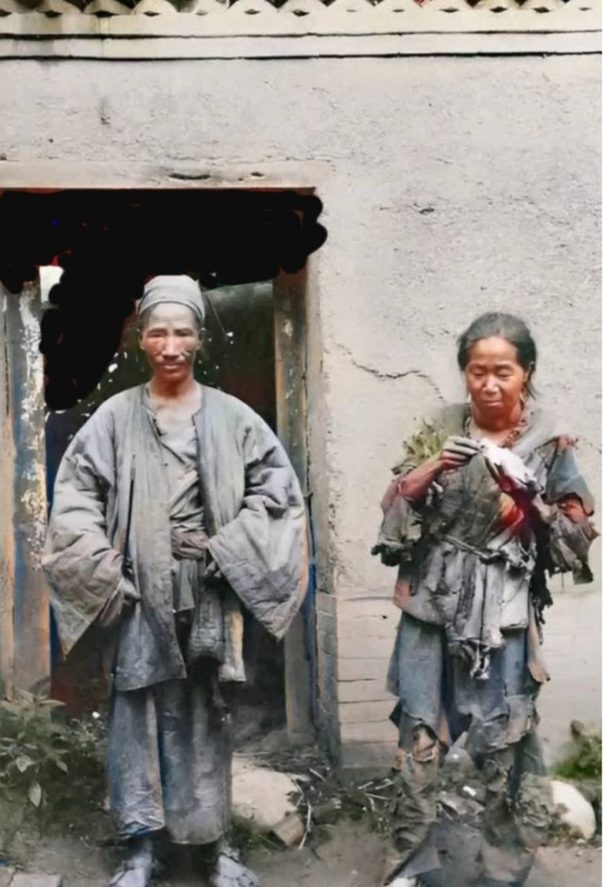 照片中的他们看起来很穷. 女人的衣服已经破烂不堪,已经散架了.